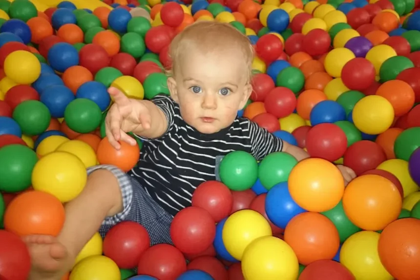 full-length-portrait-cute-boy-playing-with-colorful-balls