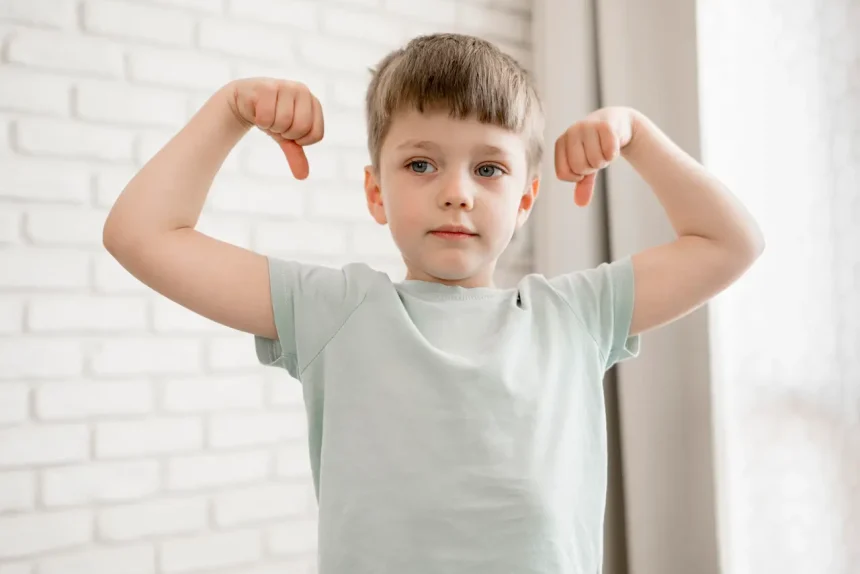 portrait-adorable-boy-showing-his-muscles