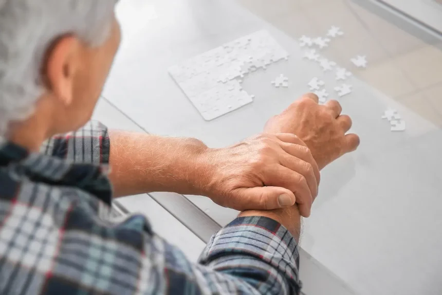 senior-man-with-parkinson-syndrome-doing-puzzle-home